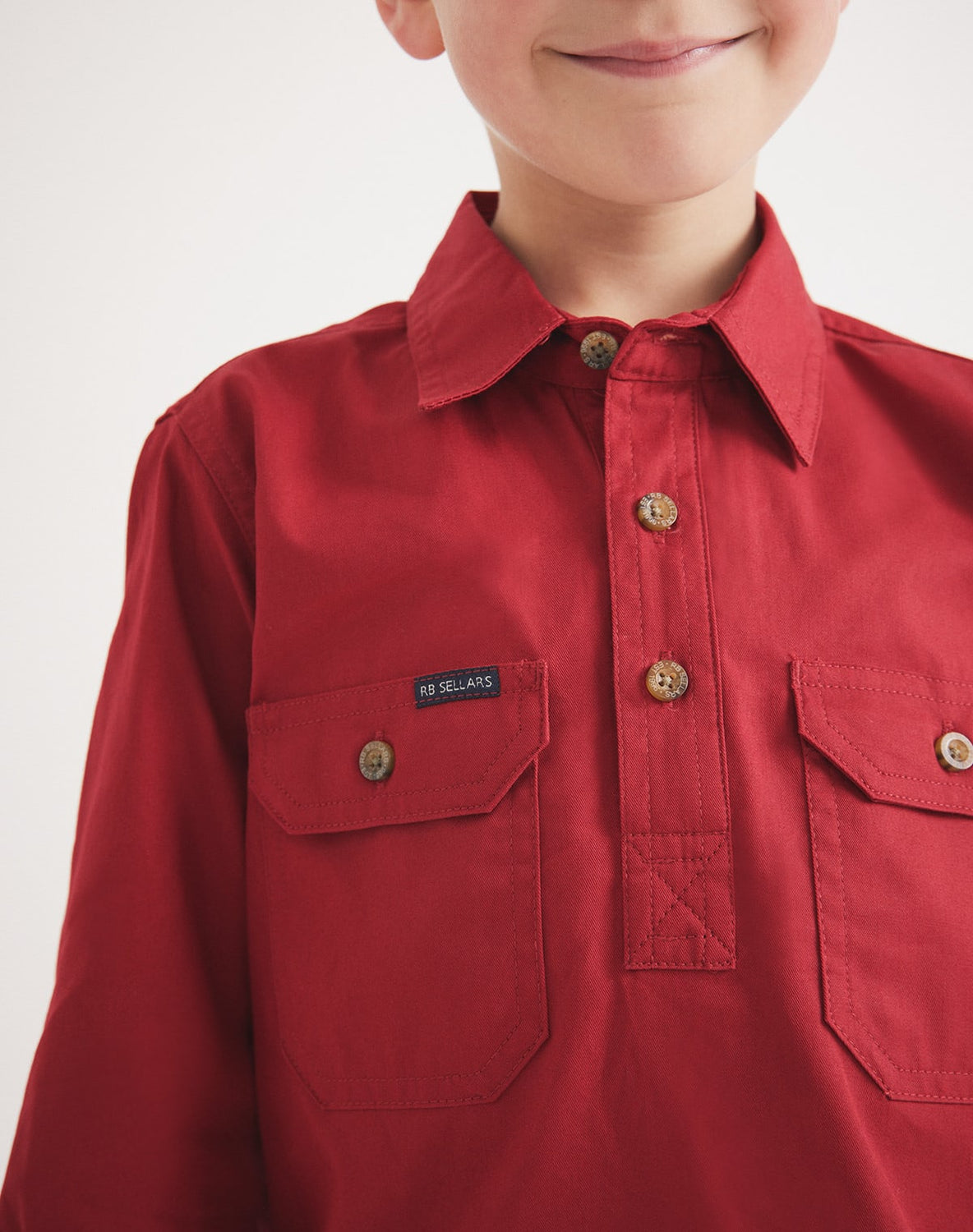 Child wearing RB Sellars red UPF 50 cotton twill shirt – great for hiking, camping, and everyday play.