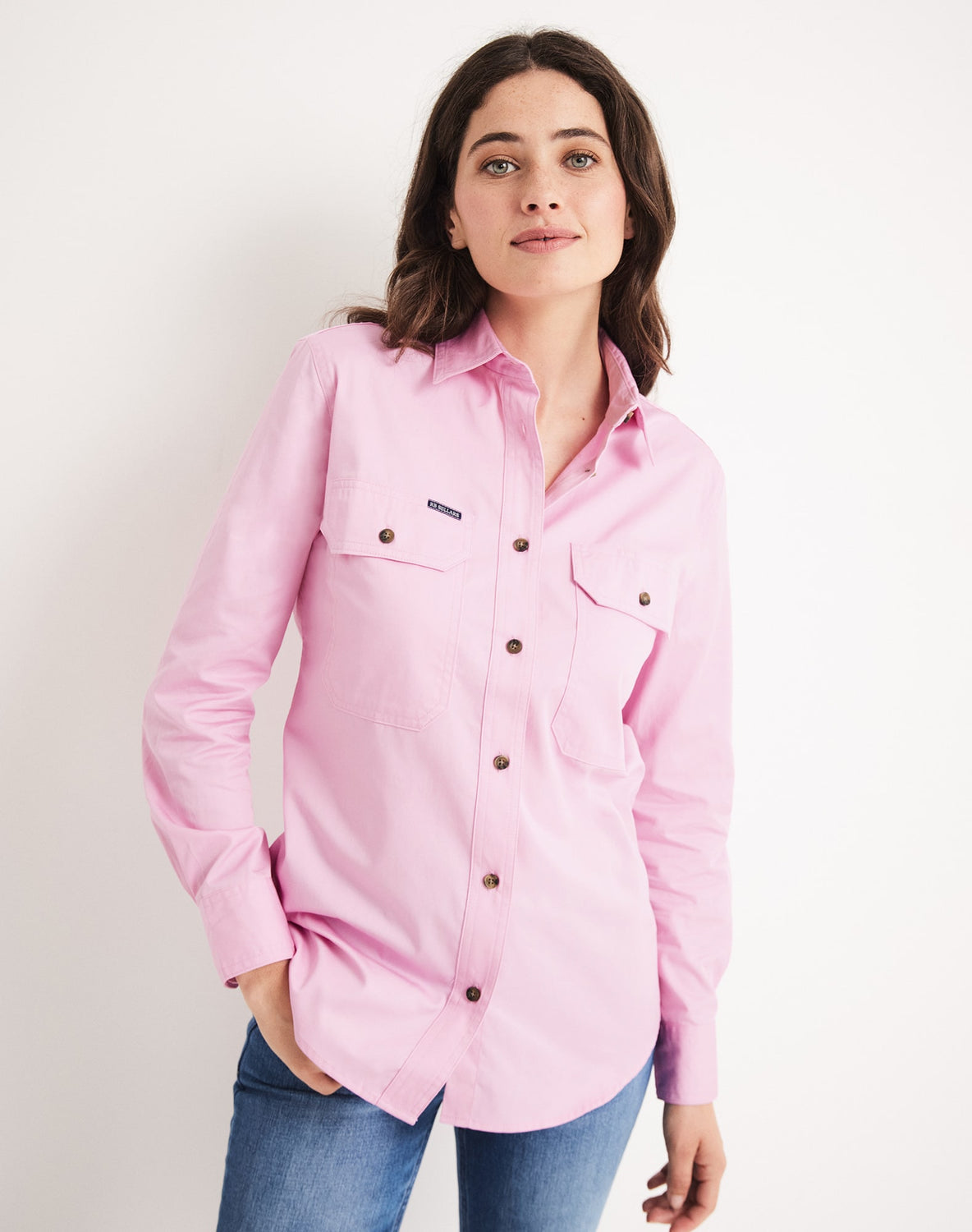 Woman wearing pink RB Sellars work shirt with jeans