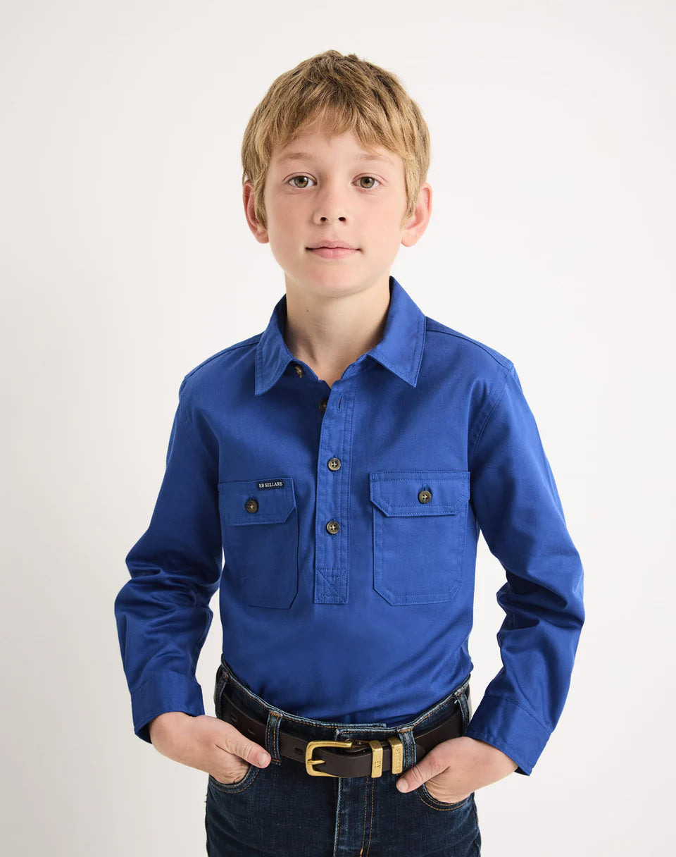Young boy wearing a blue RB Sellars shirt with a white background