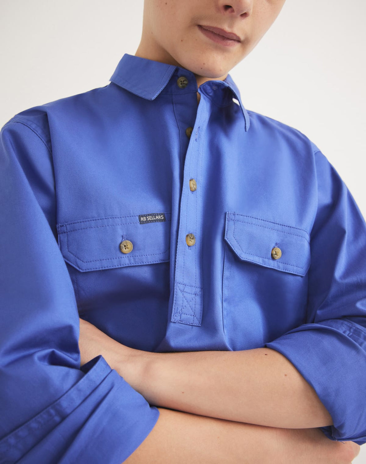 Child wearing RB Sellars blue UPF 50 cotton twill work shirt – ideal for outdoor activities, rugged play, or farm work.